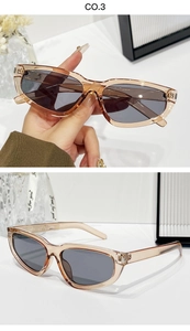 Detail of vintage cat eye sunglasses with translucent brown frames and dark grey lenses