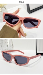 Macro shot of pink cat-eye sunglasses with CE marking and silver metal temple detail