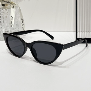 Classic black cat-eye sunglasses with dark grey lenses and minimalist sleek frames