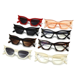 Modern cat-eye sunglasses with angular frames and gold arrow logo on temples