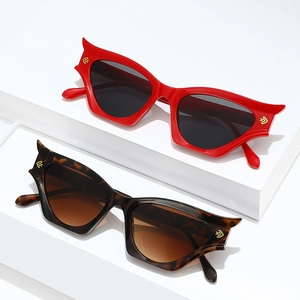 Retro cat-eye sunglasses in red and tortoise shell with metallic horn accents