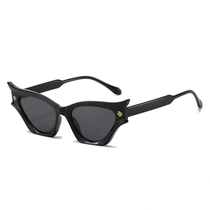 Modern retro black cat-eye sunglasses with golden wing accents and dark lenses