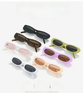 Flat lay of vintage slim cat eye sunglasses in seven glossy colors on white surface