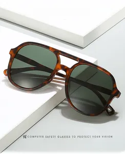 Close-up of tortoise shell aviator sunglasses with double bridge and dark green lenses