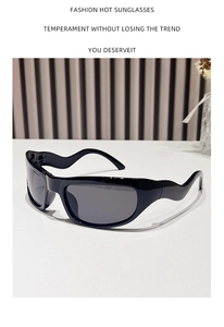 Detail of black Y2K sports sunglasses featuring unique wavy temple curves on a white surface