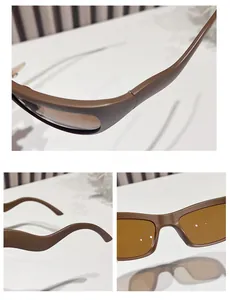 Detail view of brown matte frame Y2K cycling sunglasses with tea tinted lenses