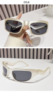 Detailed view of Y2K sports sunglasses with wavy cream frames and dark grey lenses