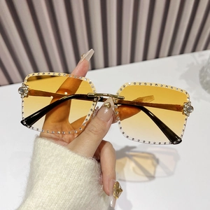Rimless square sunglasses with yellow gradient lenses and sparkling rhinestone accents