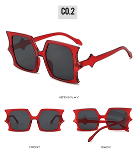 Three-angle display of red gothic bat-wing sunglasses with dark grey lenses and sharp edges