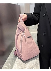 Detailed shot of a pink triangular chest bag with LSNR logo and nylon texture