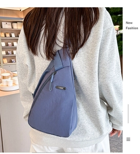 Detail of the blue durable nylon sling bag showing the metal zipper and LSNR brand logo