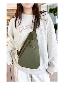 Outdoor crossbody chest bag in army green nylon with adjustable strap on model