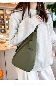 Detail showing the army green nylon chest bag texture with LSNR logo and zipper