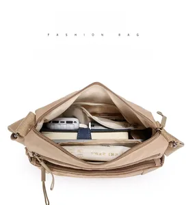 Top view of multi-compartment nylon crossbody bag showing large internal storage space