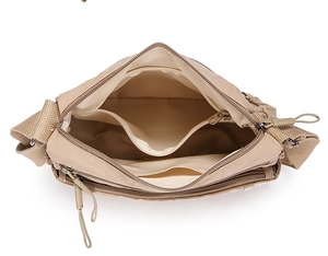 Top view of khaki nylon crossbody bag showing multiple inner compartments and zippers