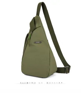 Detail showing the military green canvas chest bag with adjustable strap and metal logo