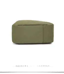 Detail view of the durable base and stitching on an army green nylon crossbody bag