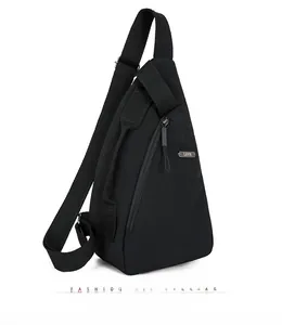 Close-up of black nylon crossbody sling bag showing the vertical zipper and metal logo