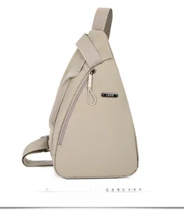 Close-up of minimalist beige crossbody bag featuring nylon texture and LSNR logo detail