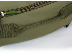 Detail view of military green crossbody bag with woven handle and corded metal zipper