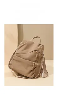 Detail of waterproof corduroy backpack featuring woven zipper pulls and pleated texture