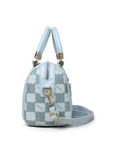 Detail of light blue crossbody bag featuring repeated kmJm pattern and gold hardware