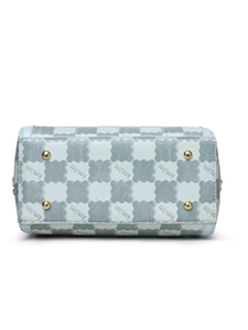 Detail of light blue handbag base with embossed pattern and four gold metal protective feet