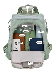 Internal storage view of green corduroy backpack showing large capacity and multi-pockets