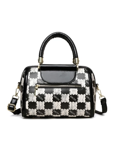 Detail of checkered Boston bag featuring cloud pattern and gold hardware accents