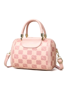 Detail view of pink Boston bag with floral patterns, tubular handles and gold hardware
