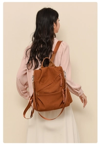 Close-up of waterproof corduroy backpack with textured vertical stripes and side zip detail