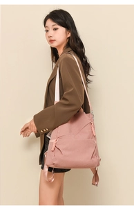 Detailed texture of pink corduroy backpack with woven straps and smooth zippers