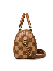 Macro detail of Boston handbag showing golden zipper and brown bear monogram print