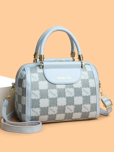 Detail of Boston handbag showing geometric kmJm pattern and Perfect Lily lettering