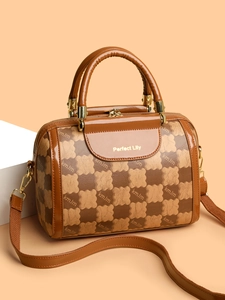Detail of Boston bag with kmJm print, dual handles and golden hardware accents