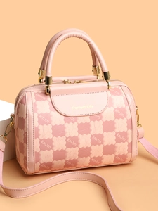 Detail showing pink Boston bag with monogram pattern and gold Perfect Lily logo