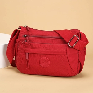 Red multi-pocket nylon crossbody bag for women with adjustable strap and zip closures