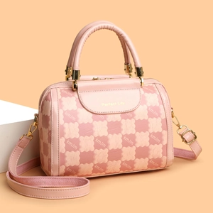 Pink Boston handbag with bear pattern print and adjustable strap in a 45-degree angle view