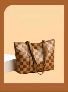 Detail of vintage tote bag featuring brown kmJm monogram pattern and smooth PU leather strap
