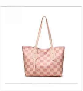 Detailed front view of pink checkerboard tote bag featuring KMJM monogram pattern