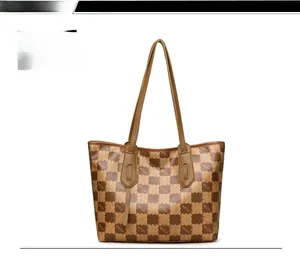 Detail view of large brown checkerboard tote bag with KMJM logo and long shoulder straps