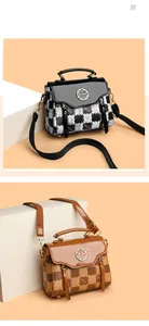 Close-up of square patterned handbags with clover metal buckles in black and brown