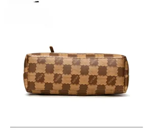 Detailed bottom view of large brown checkerboard tote bag with floral logo texture