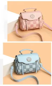 Detail of checkered leather handbags in pink and blue with clover metal buckles