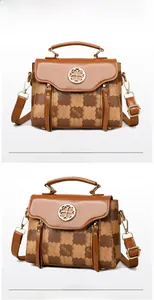 Detailed view of structured color-block handbag with checkerboard pattern and metal clasp