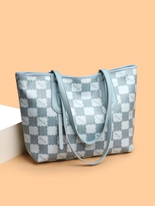 Close-up of kmJm patterned tote bag featuring grey-blue handles and high-quality faux leather
