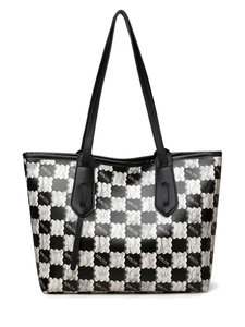 Close-up of checkerboard tote bag with wavy white patterns and logo text print