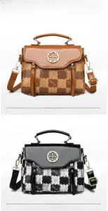 Close-up of brown and black leather handbags featuring checkered patterns and metal clover logos