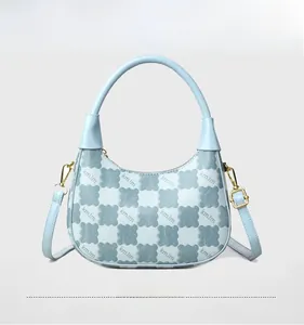 Detail of light blue hobo bag showing kmJm letter embossing and gold hardware