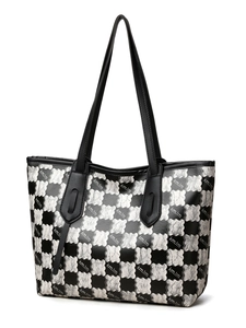 Side 45-degree angle of a large checkerboard tote bag with black and white kmJm print